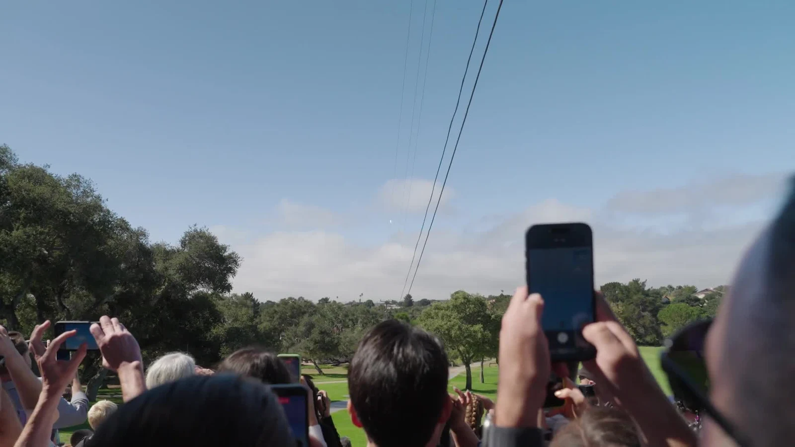 People holding up phones during a launch in the official Project Suncatcher prototype video thumbnail.