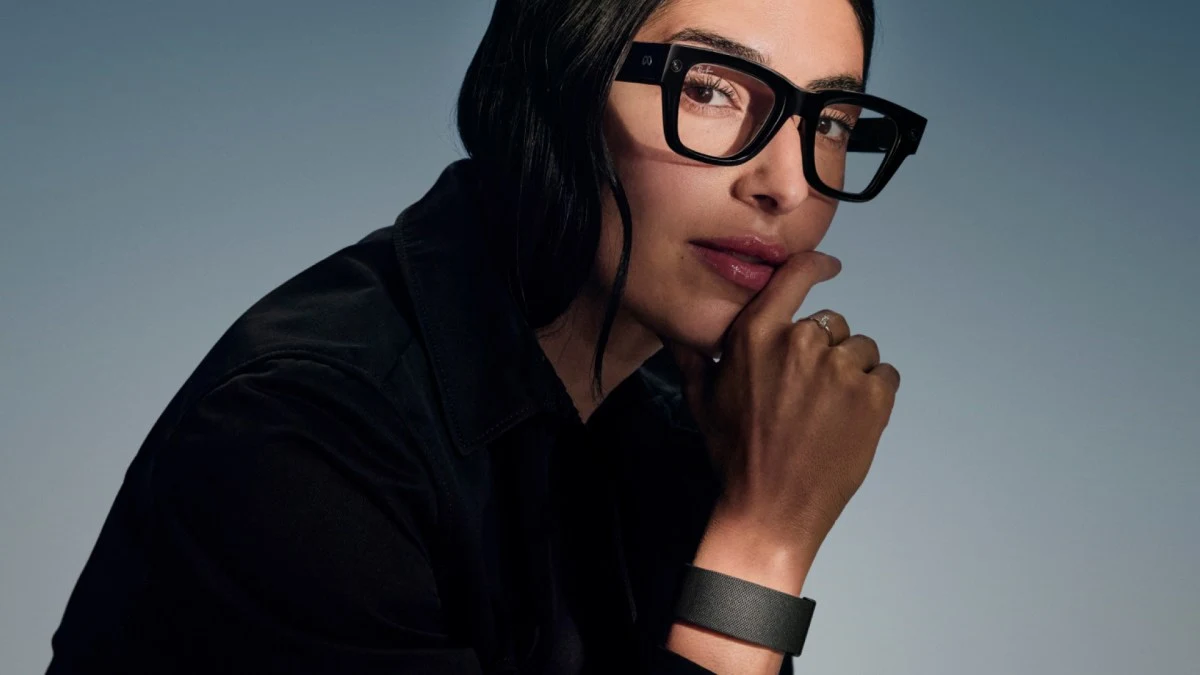 A woman wearing Meta Ray-Ban Display glasses and the accompanying wristband.